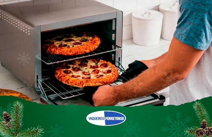 hombre usando horno eléctrico para pizzas 