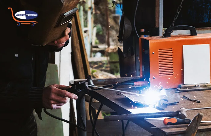 Persona con máscara trabajando con una máquina de soldar
